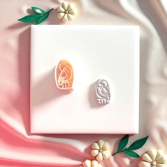 cute owl with moon design on clay with cutter next to it