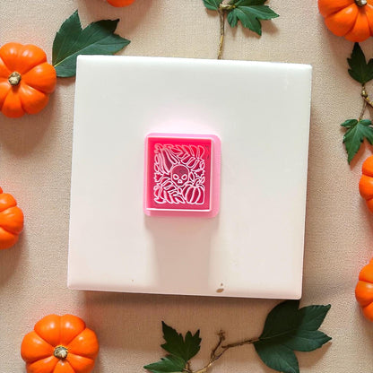 Pink Matisse skull and pumpkin polymer clay cutter on tile