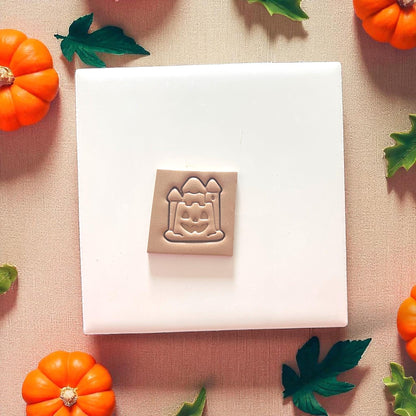 close-up of halloween pumpkin sandcastle clay impression