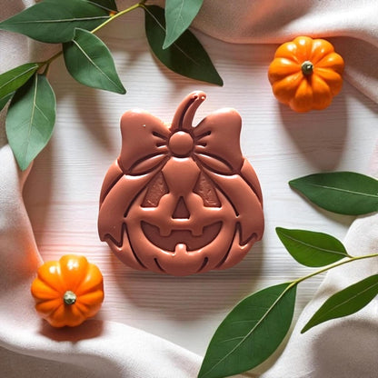 Detailed view of jack-o-lantern bow design in clay impression
