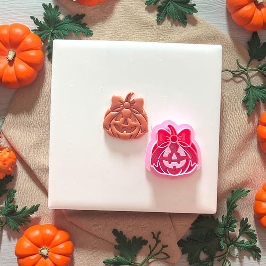 Clay cutter and matching stamp showing pumpkin and bow design