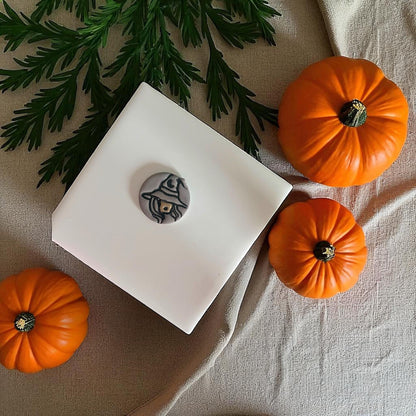 Painted sexy witch clay piece with orange pumpkins and greenery
