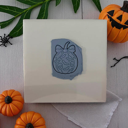 Pumpkin bow clay cutter with bats and skulls design pressed in clay