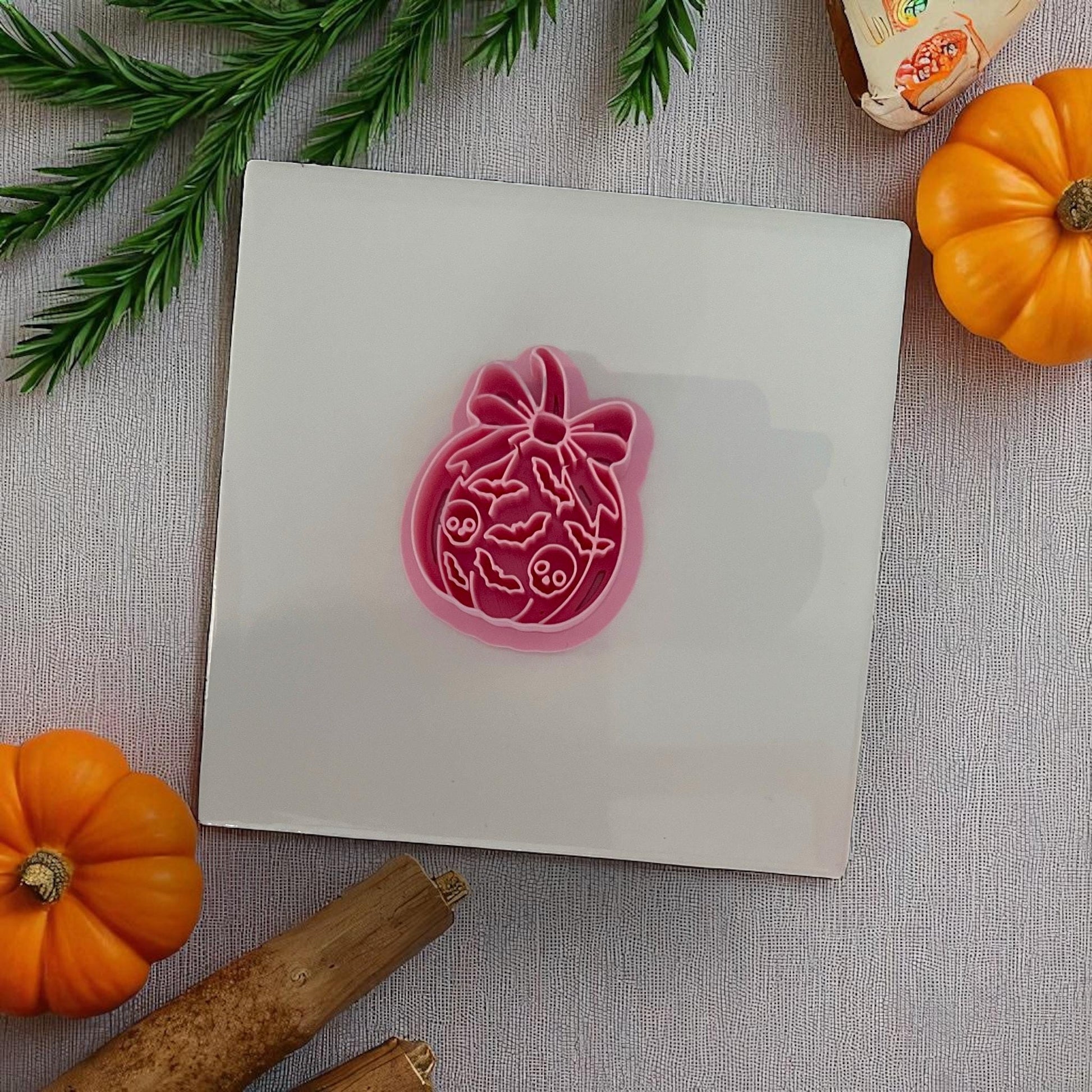 Pink pumpkin bow clay cutter with bat and skull pattern