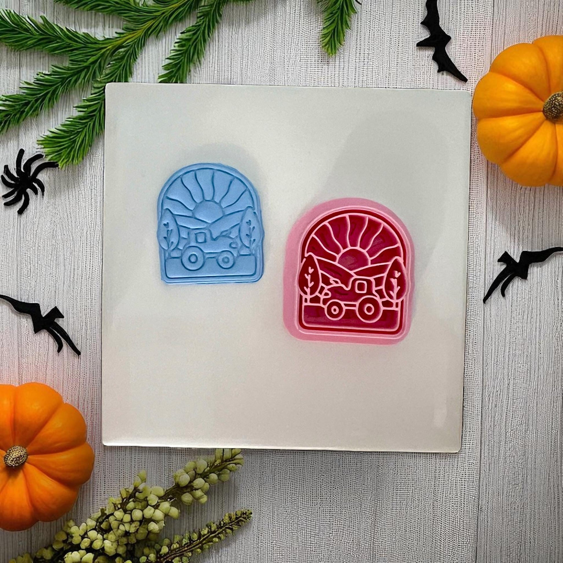 Two tractor sunset clay cutters in blue and pink with Halloween decor