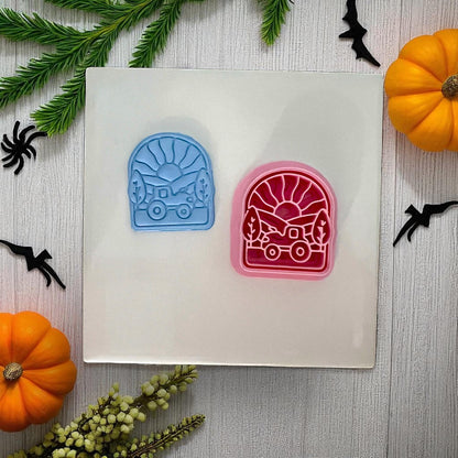 Two tractor sunset clay cutters in blue and pink with Halloween decor
