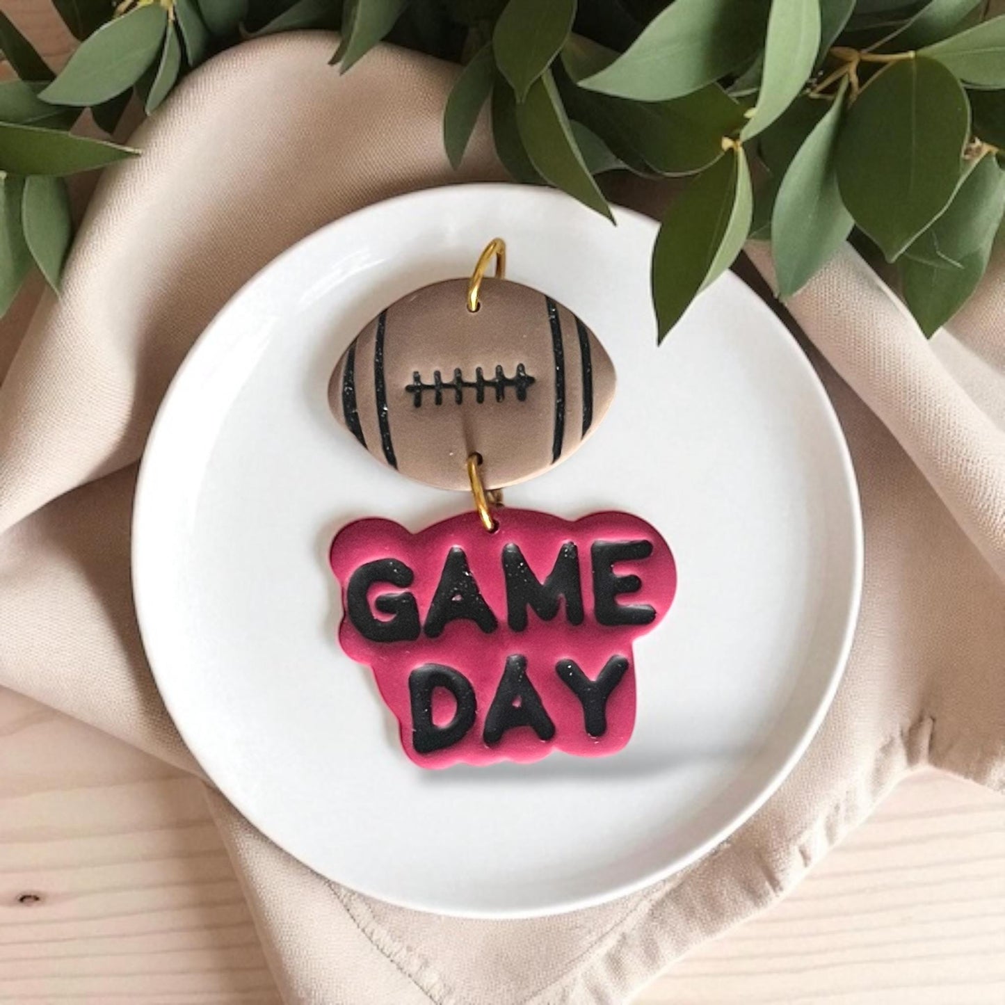 Football Game Day polymer clay earrings displayed on white plate