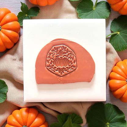 Stamped ornate pumpkin in uncut clay slab