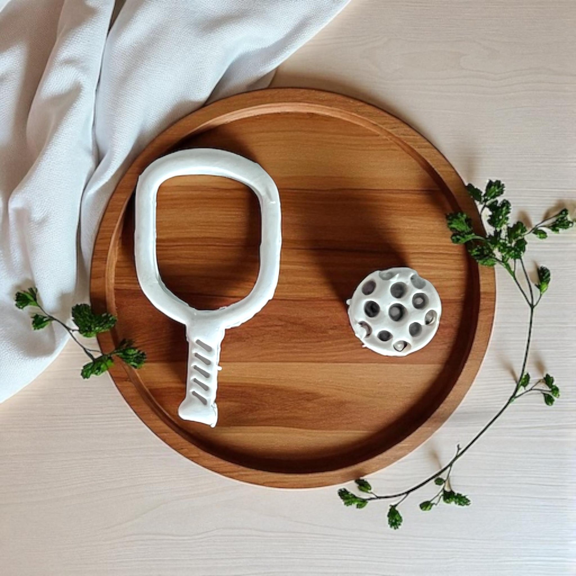 pickleball racket and ball on plate