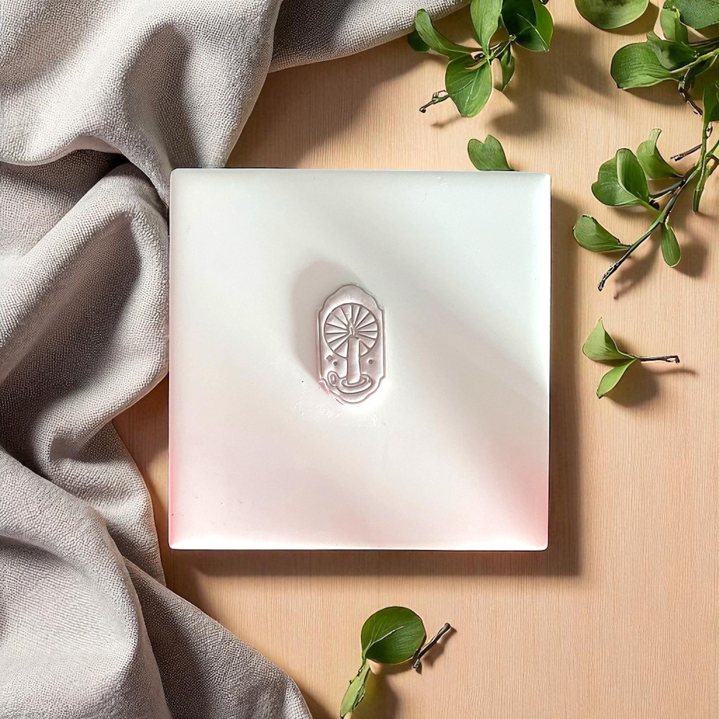 small candle window clay impression centered on white tile