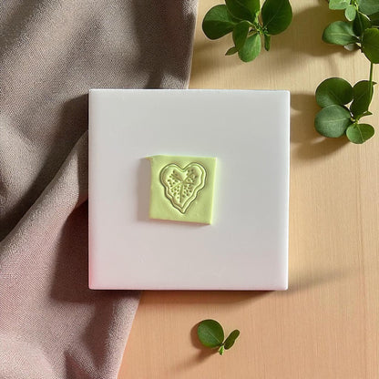 Caladium heart leaf clay impression on white tile