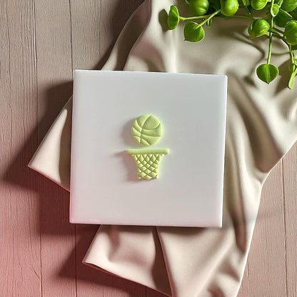 basketball net polymer clay cutout on white tile