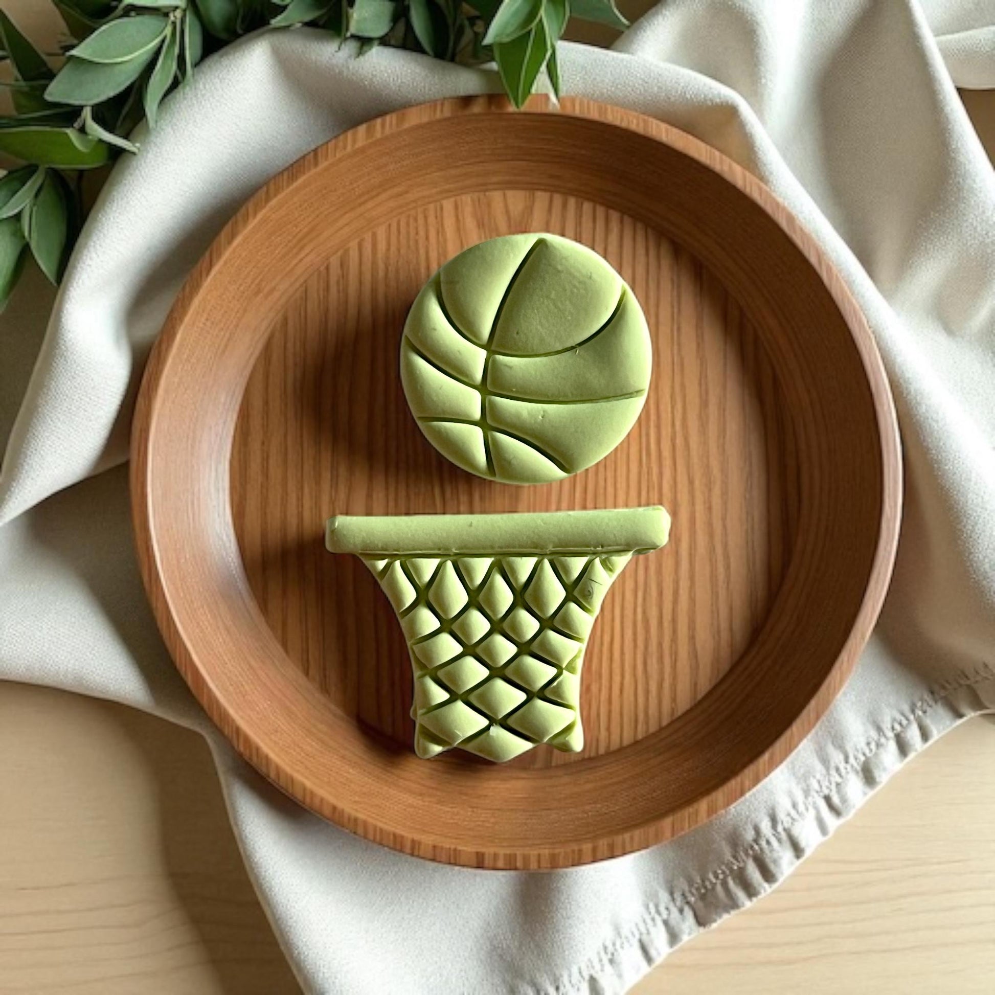 large basketball earring clay design on wood plate