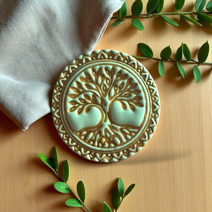 Green clay impression of Tree of Life design with ornate border