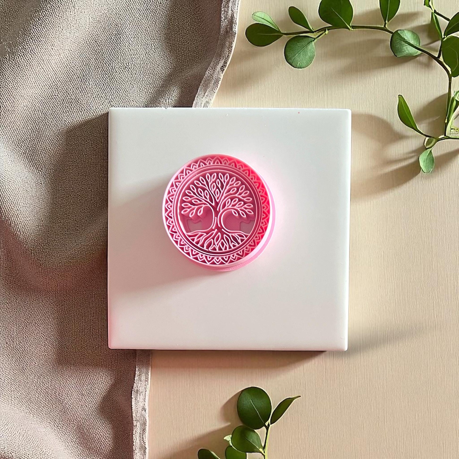 Yellow and pink Tree of Life clay stamps displayed side by side