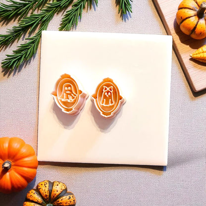 Top view of Mr. and Mrs. ghost portrait cutters placed on white tile with Halloween decor
