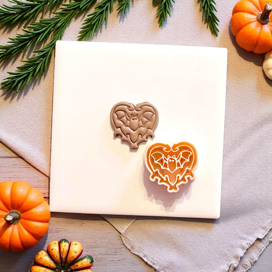 Clay piece beside orange bat heart cutter