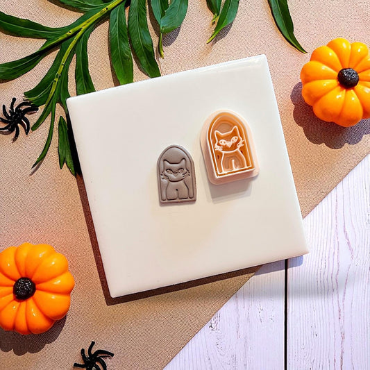 Spooky cat clay imprint with matching cutter next to it