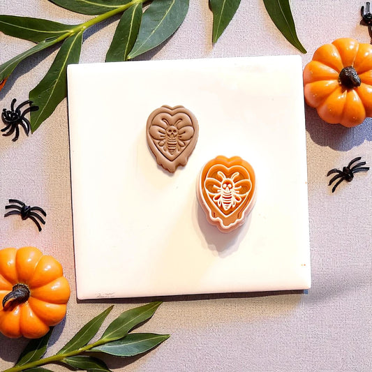 Skull moth clay impression with cutter shown, surrounded by fall decor and spiders