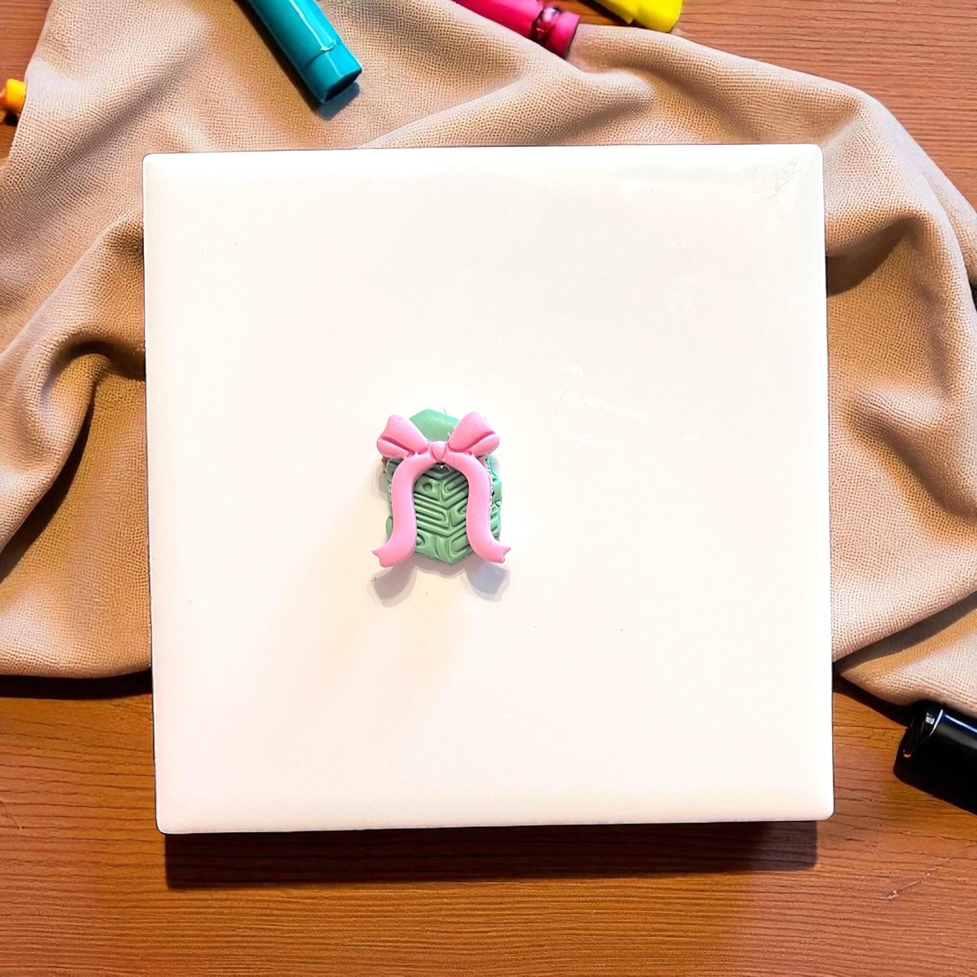 bow clay impression next to book