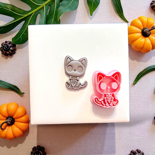 Spooky cat skeleton cutter with matching clay result side by side
