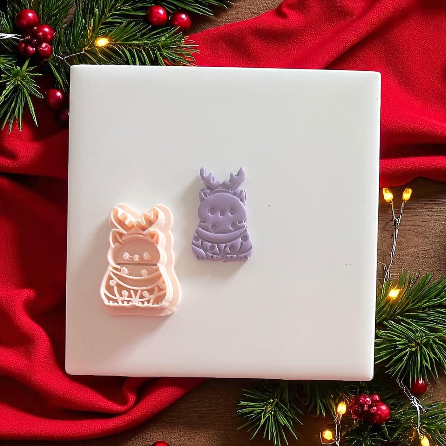Reindeer cat clay cutter next to stamped imprint