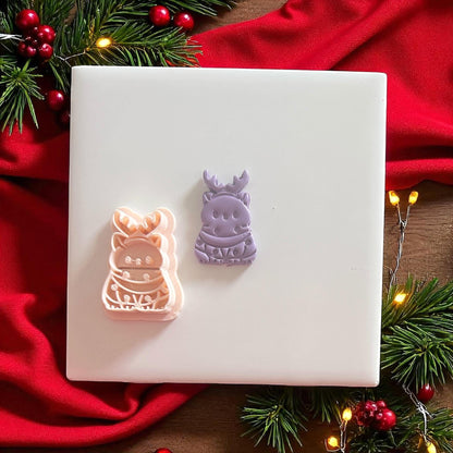 Reindeer cat clay cutter next to stamped imprint