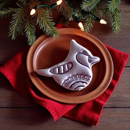 Cardinal bird clay cutter tool on white tile