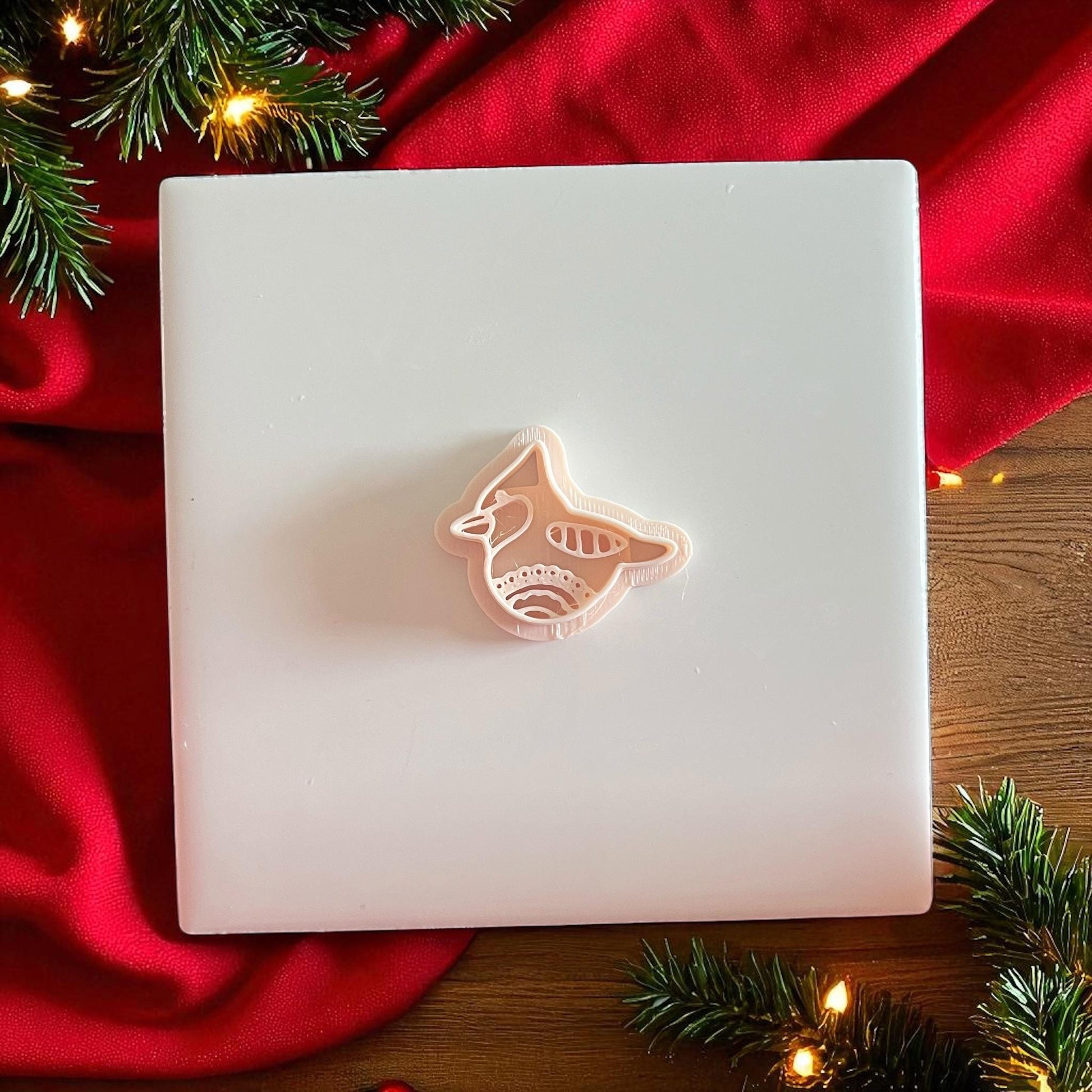 Polymer clay cutter and bird imprint side by side