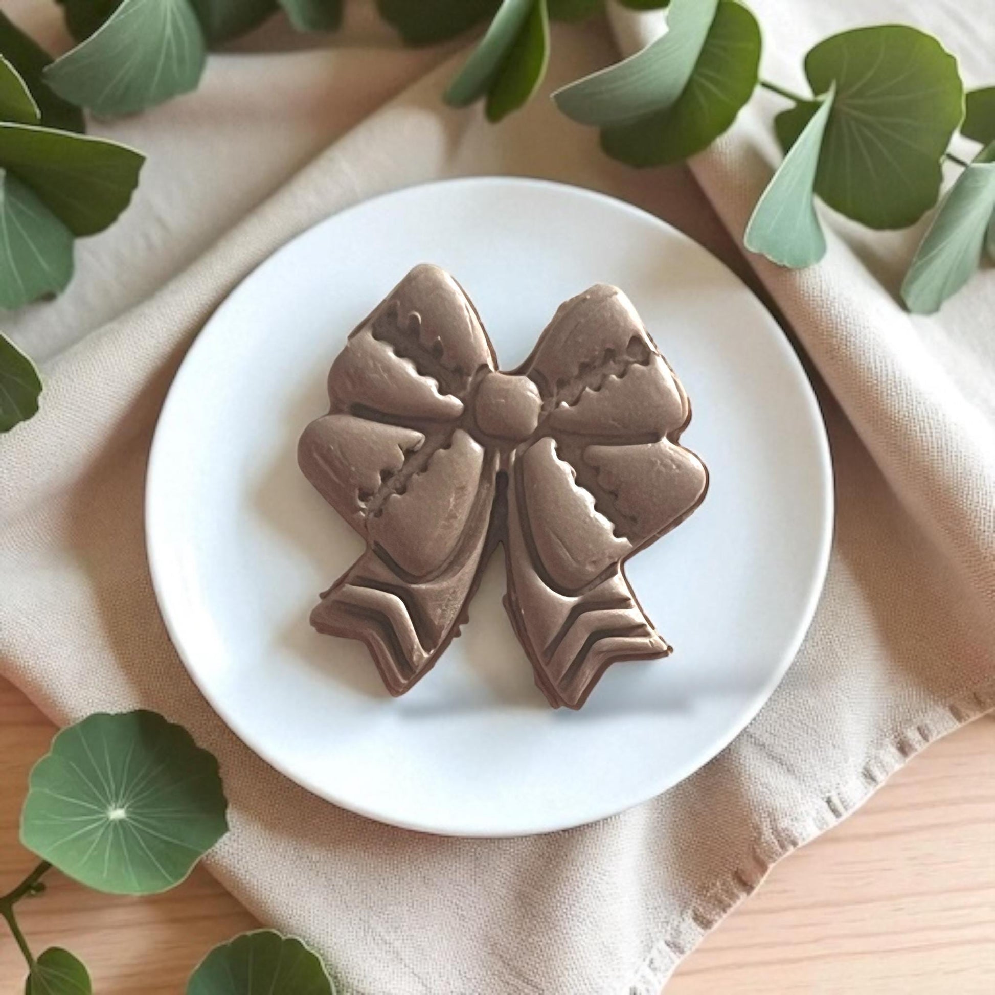 Football ribbon bow clay cutter tool displayed on tile