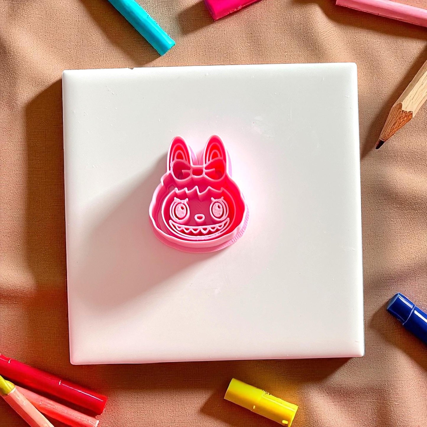 Red monster girl head polymer clay cutter with bow detail