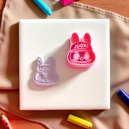 Monster SKOOL hat cutter next to matching clay imprint