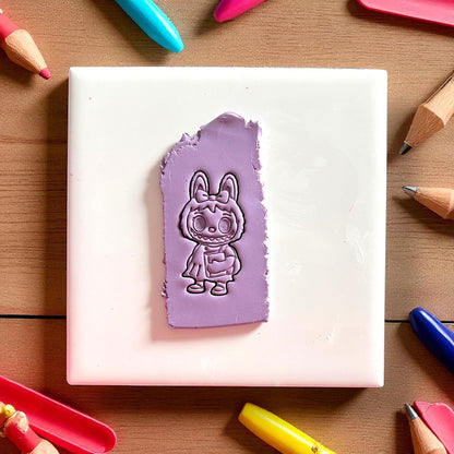 Back-to-school monster girl clay cutter on purple clay