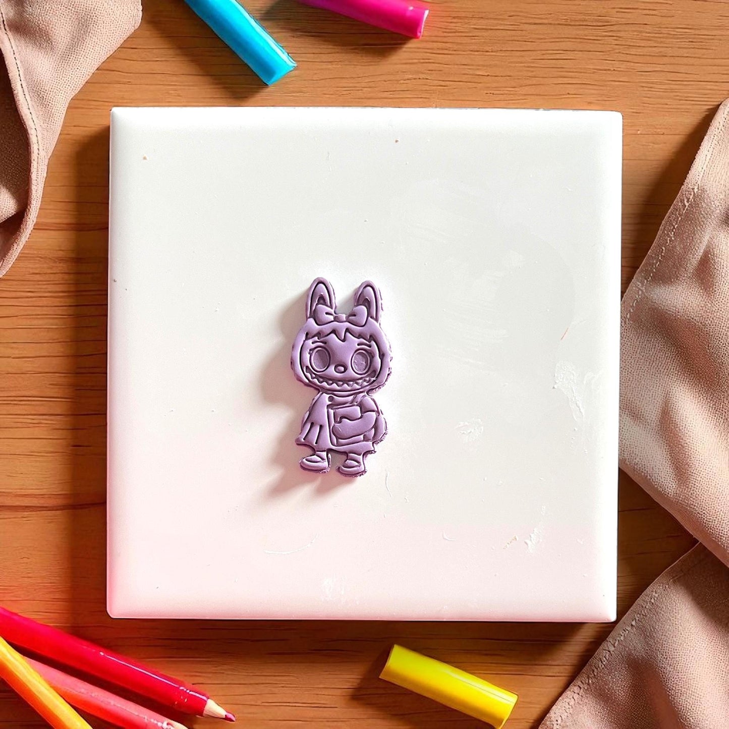 Purple monster girl clay impression with bow and books