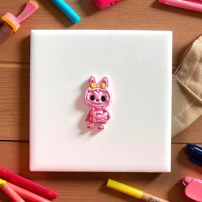 Painted monster girl clay cutter in pink and yellow