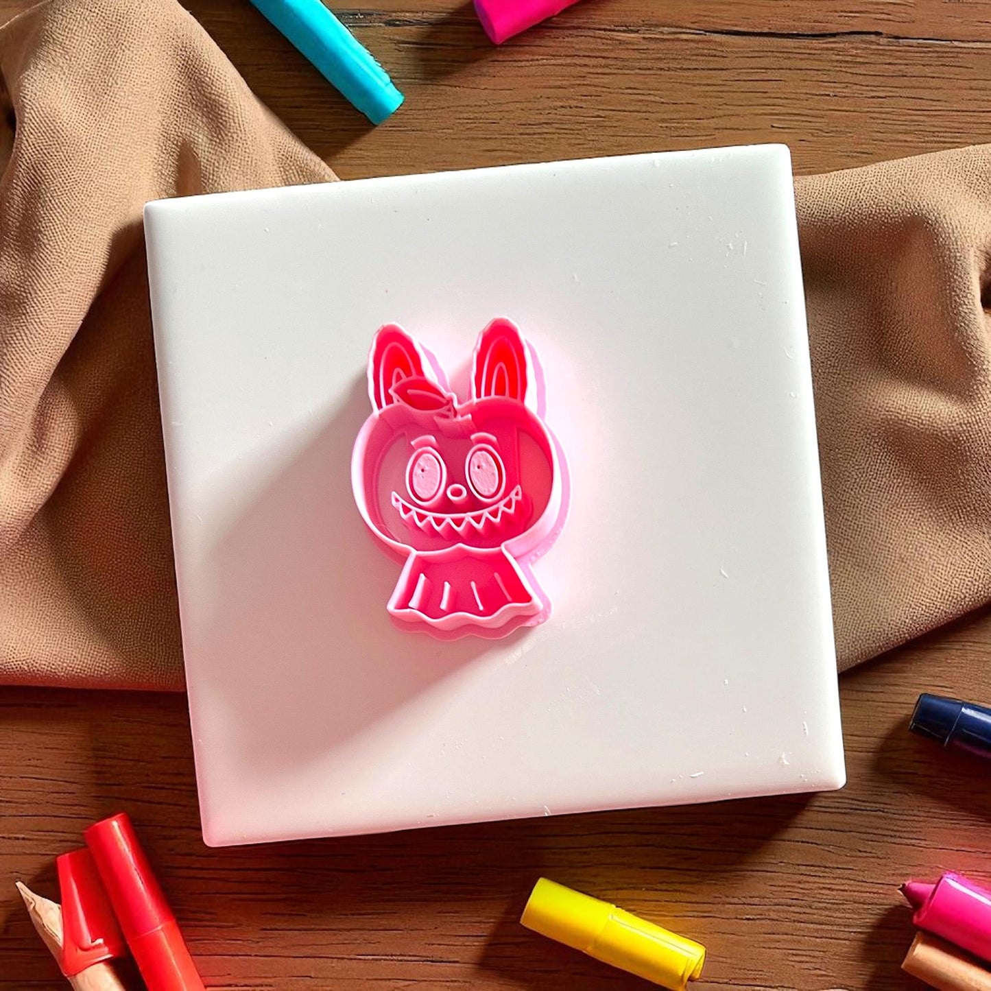 Red polymer clay cutter shaped like scary apple monster character