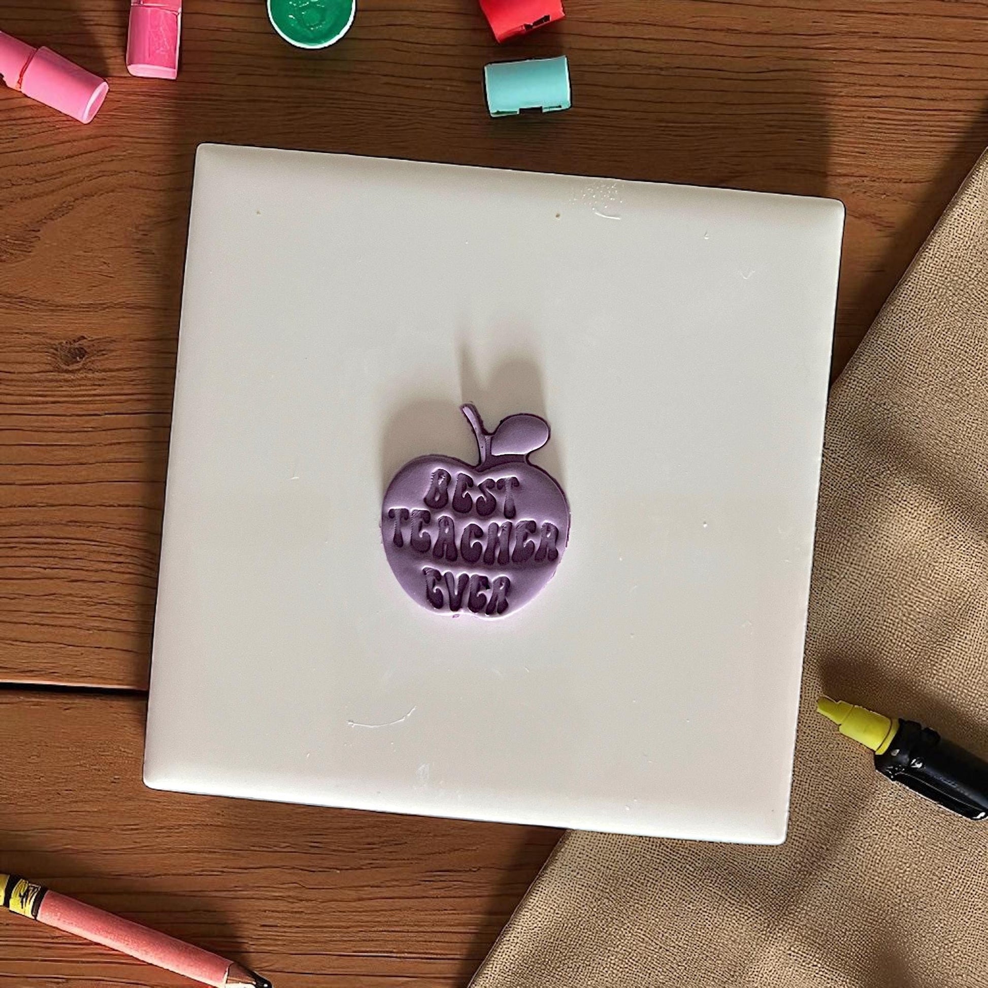 best teacher ever apple clay impression on purple clay circle on white tile