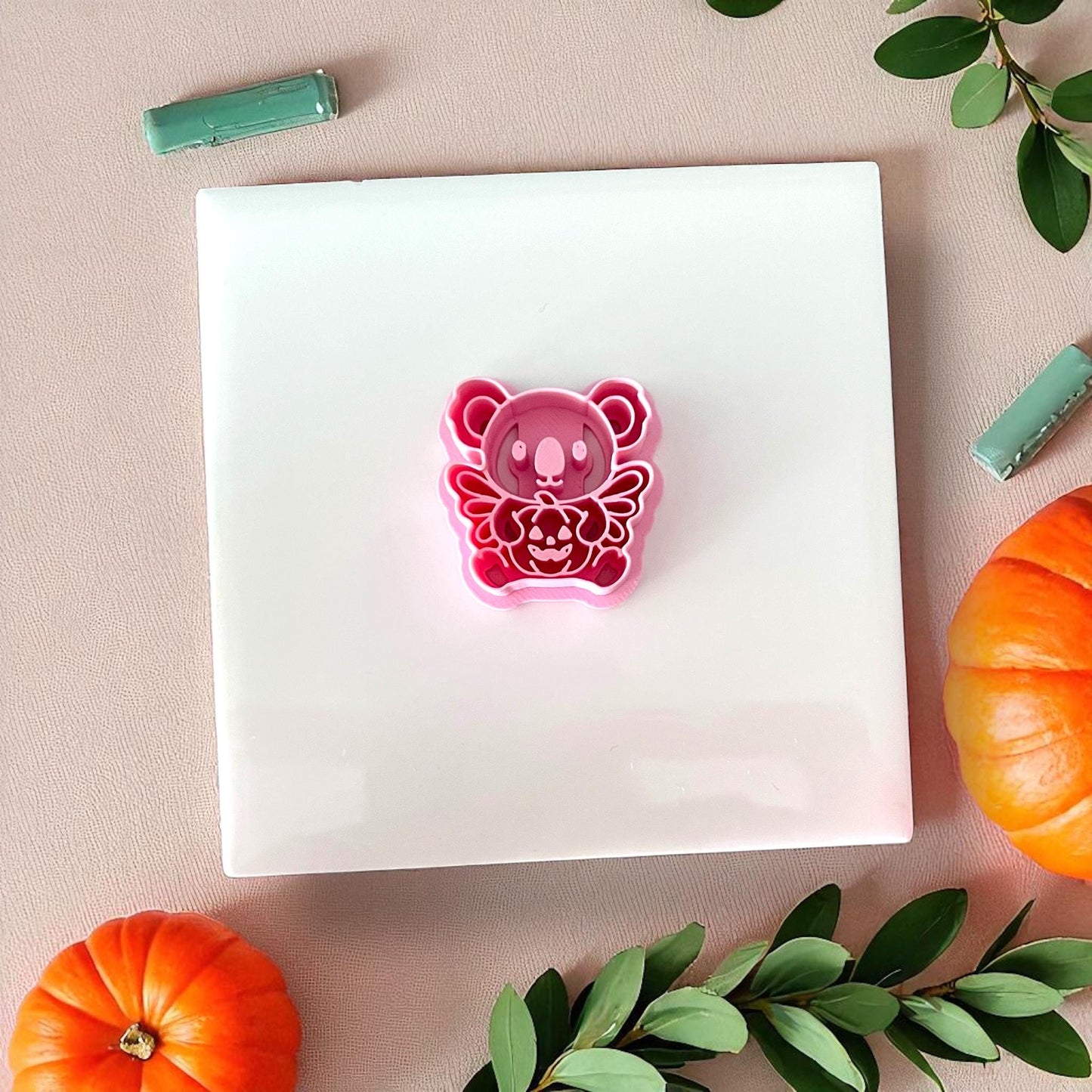 Pink koala pumpkin clay cutter on white tile