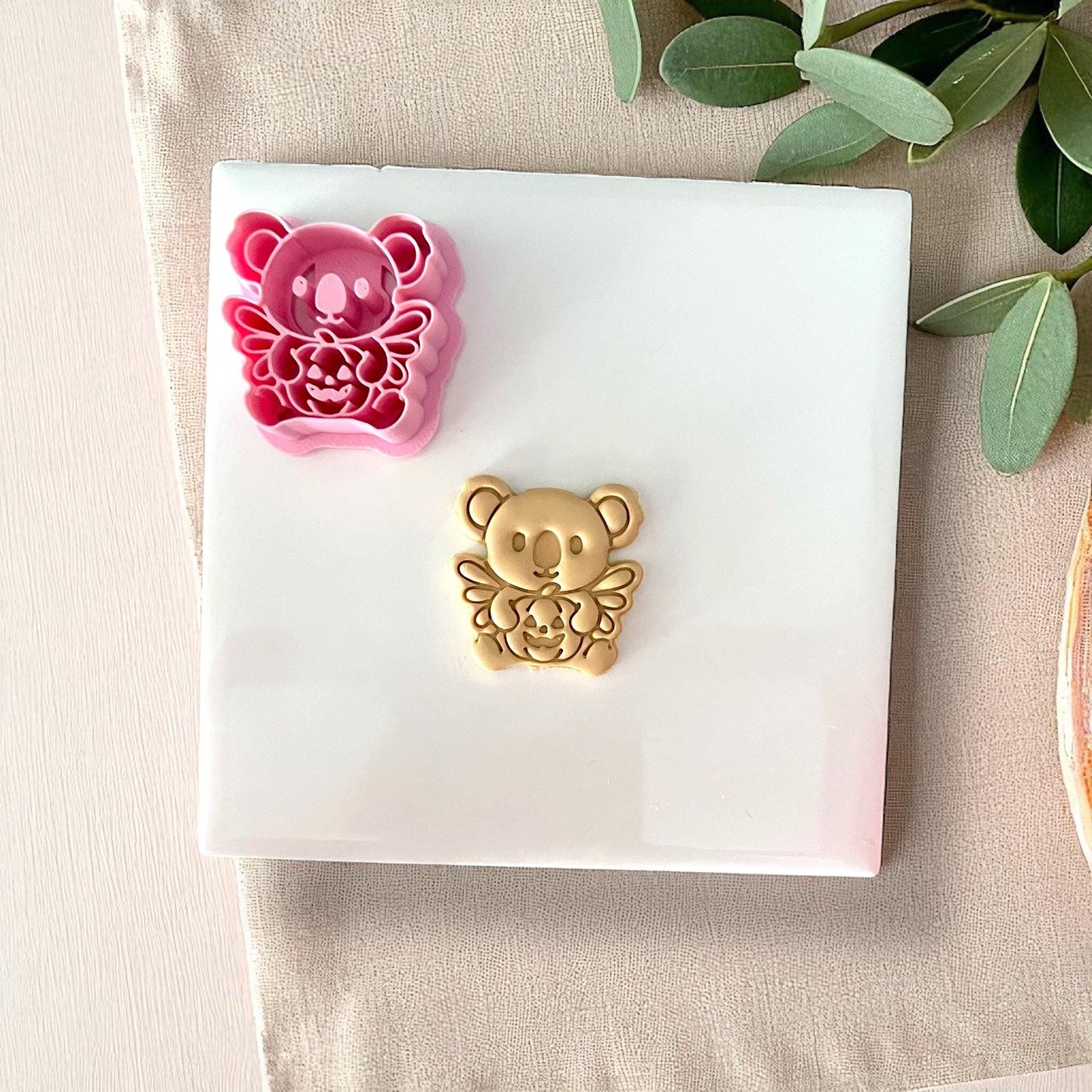 Pink koala pumpkin clay cutter with finished golden clay piece