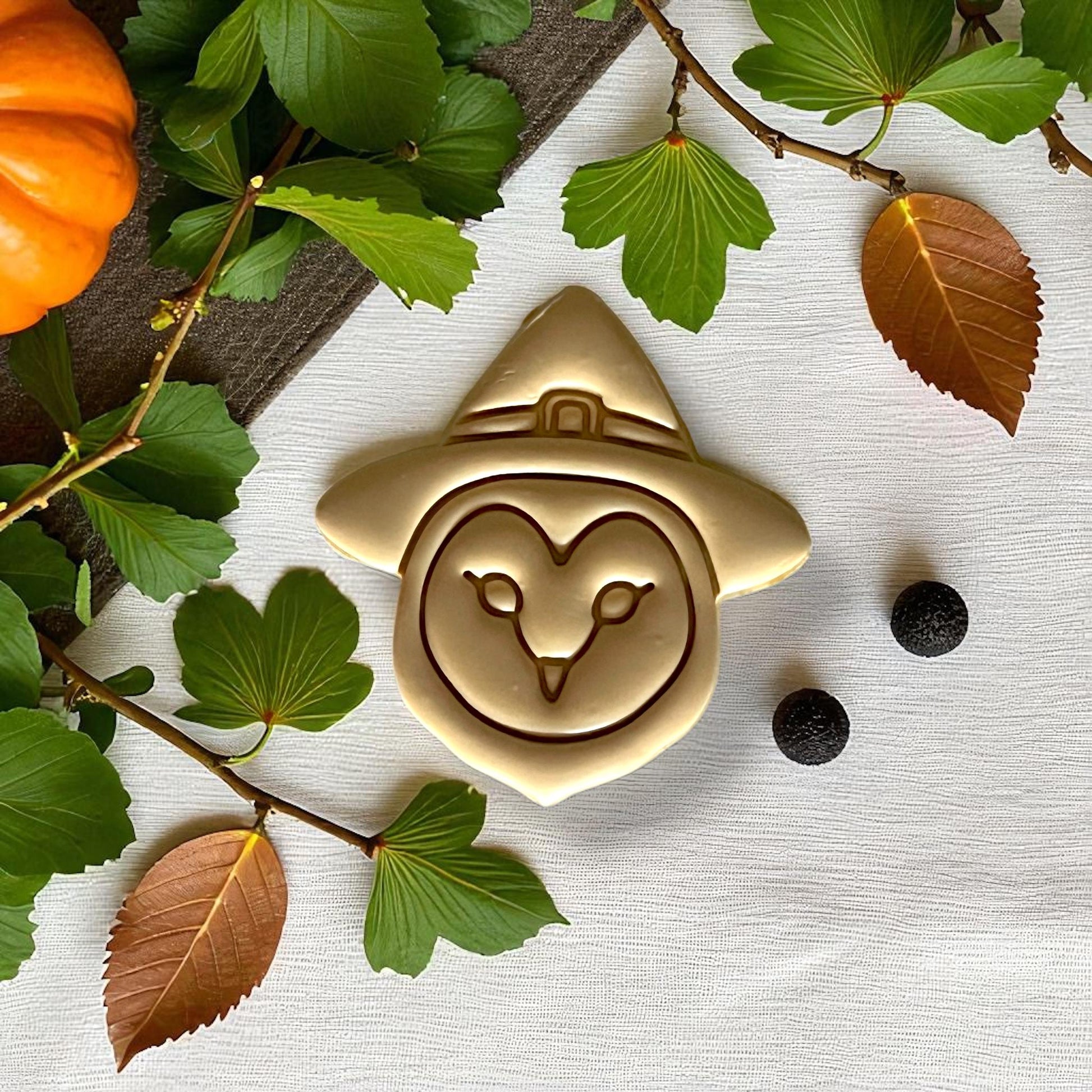 Close-up golden owl in witch hat clay design