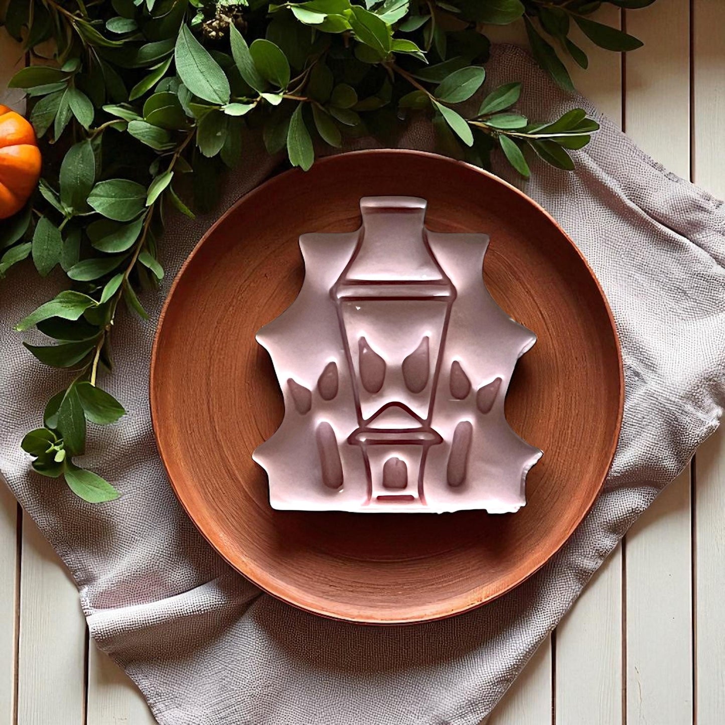 Large haunted house clay design on wooden plate