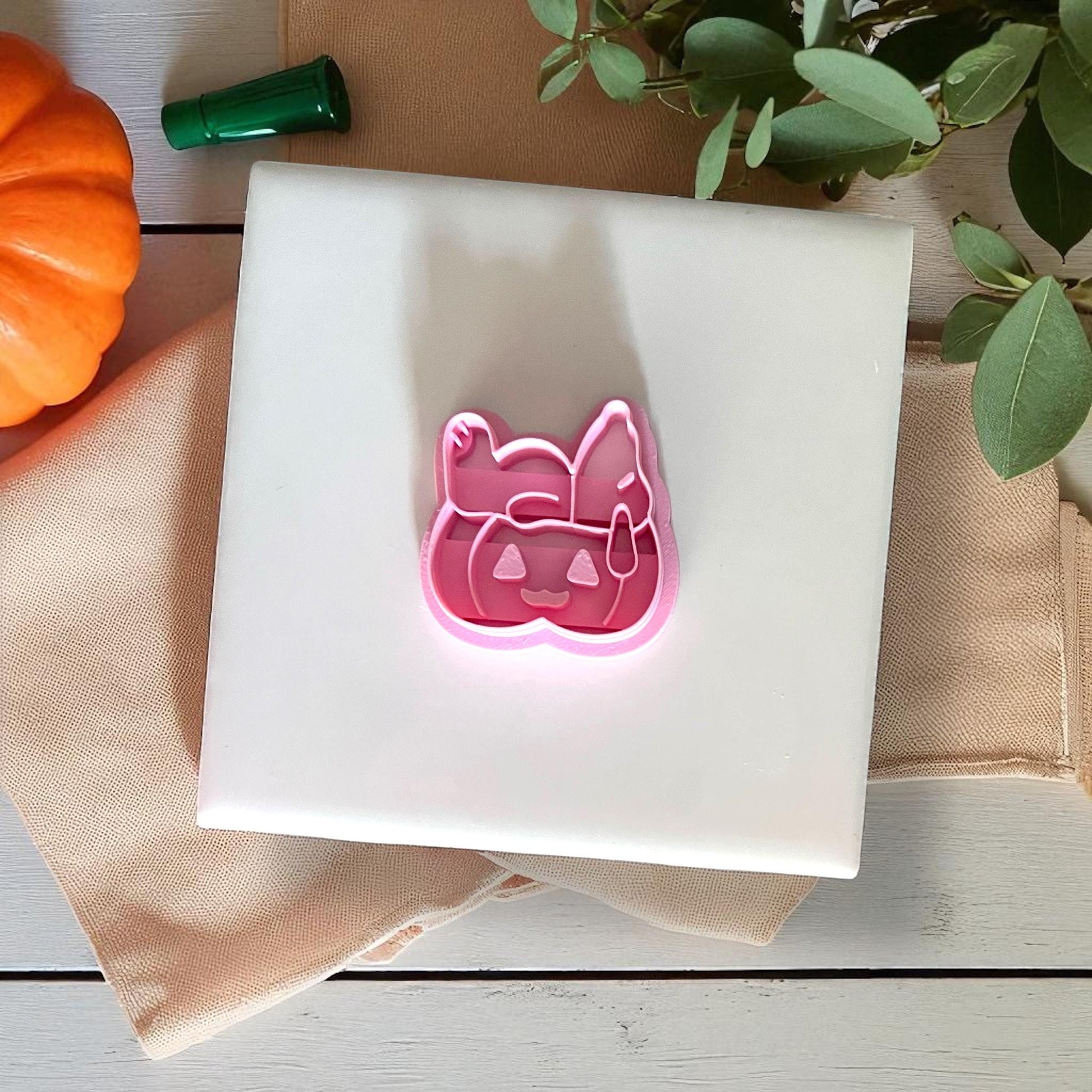 Pink beagle pumpkin clay cutter on white tile