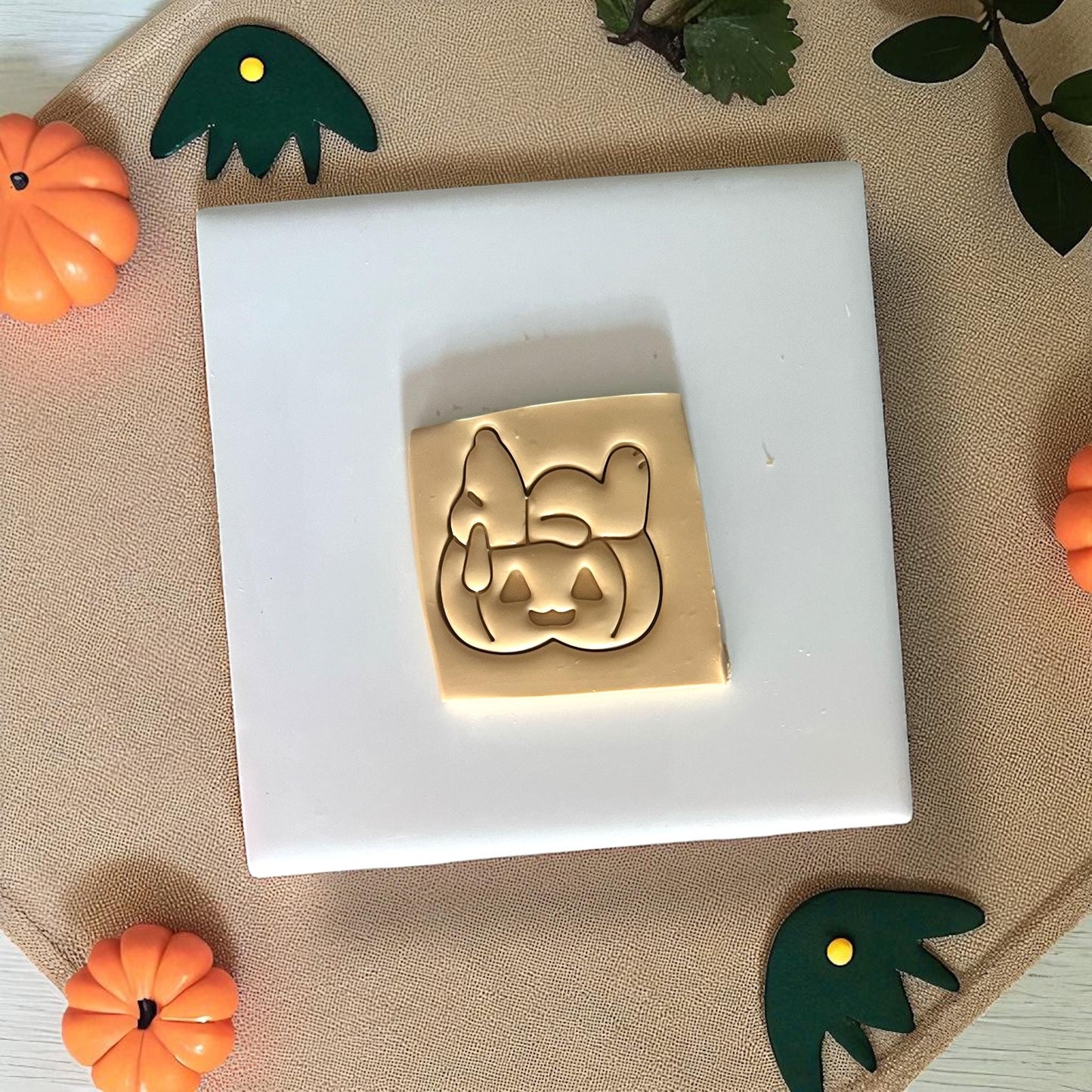 Beagle sitting on pumpkin clay impression