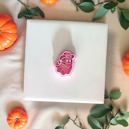 Cowboy ghost pink cutter on white tile with pumpkins