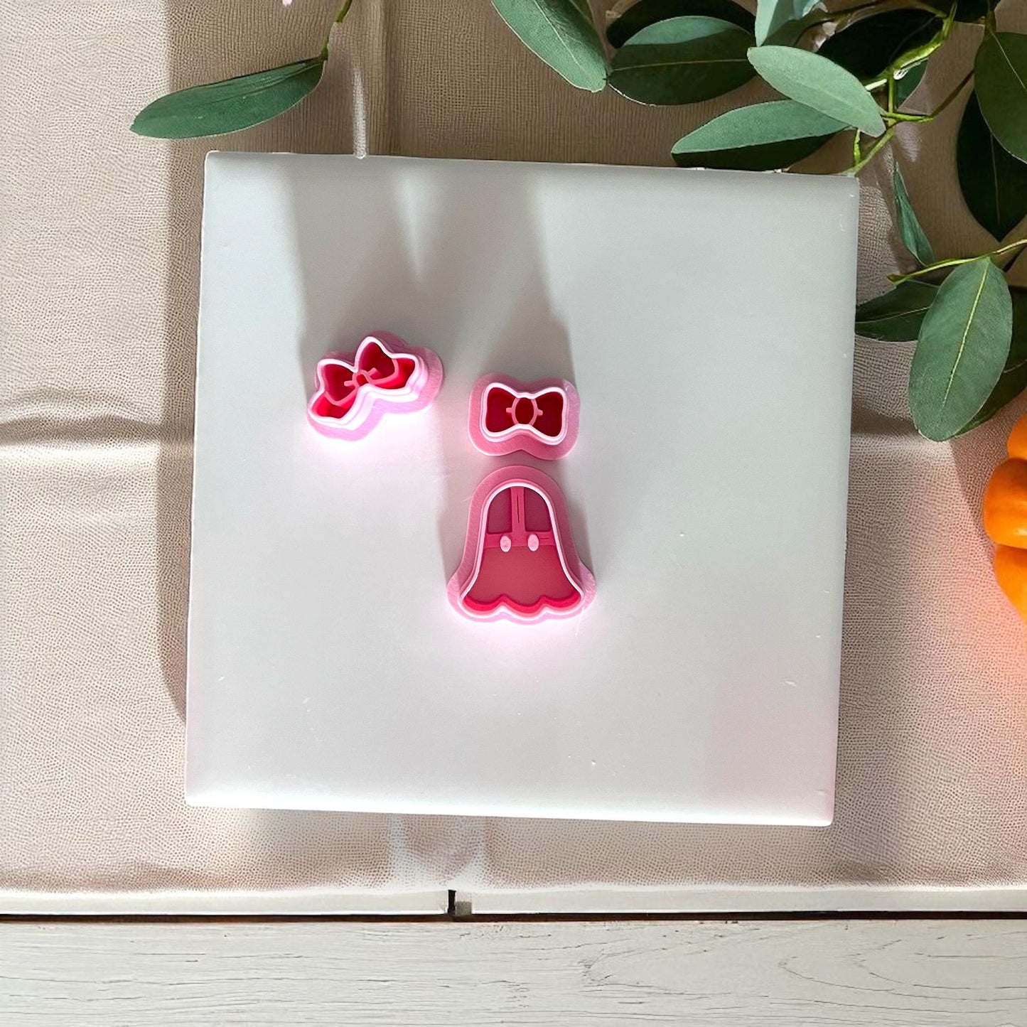 Pink ghost and bow cutters on white tile