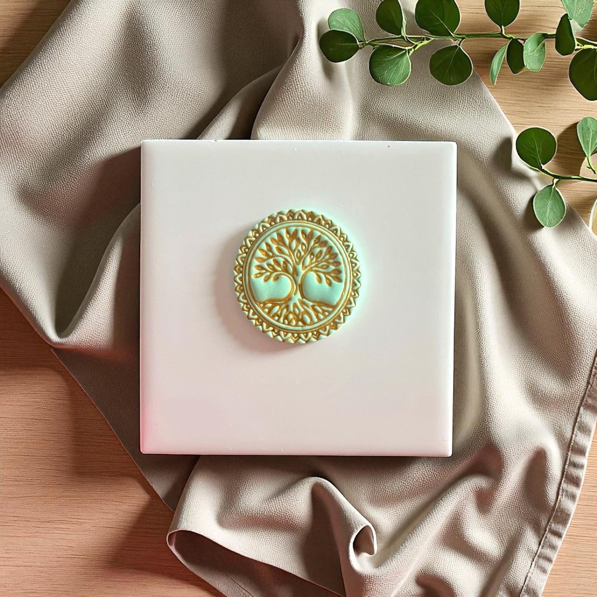 Yellow Tree of Life clay stamp on white tile with leaves