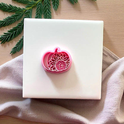 Pink sunflower pumpkin clay cutter on fabric
