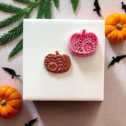 Cutter and clay sunflower pumpkin design on white tile