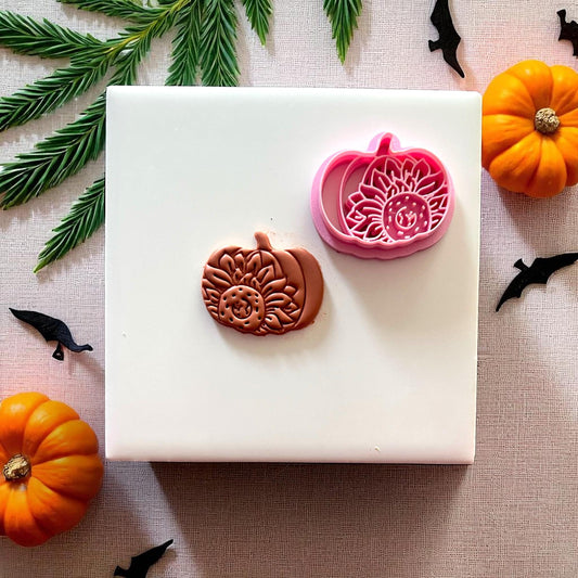 Cutter and clay sunflower pumpkin design on white tile