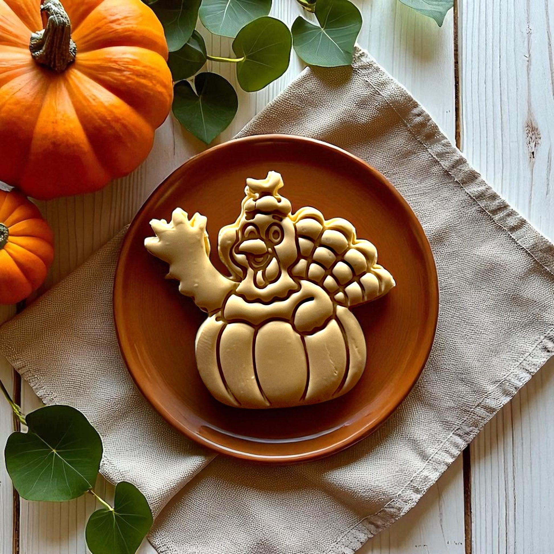 Large turkey pumpkin clay piece on brown plate with pumpkins